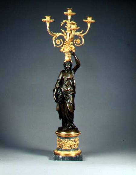 Louis XVI four-light candelabraormolu branches rising from a basket balanced on the head of a patina à Anonyme
