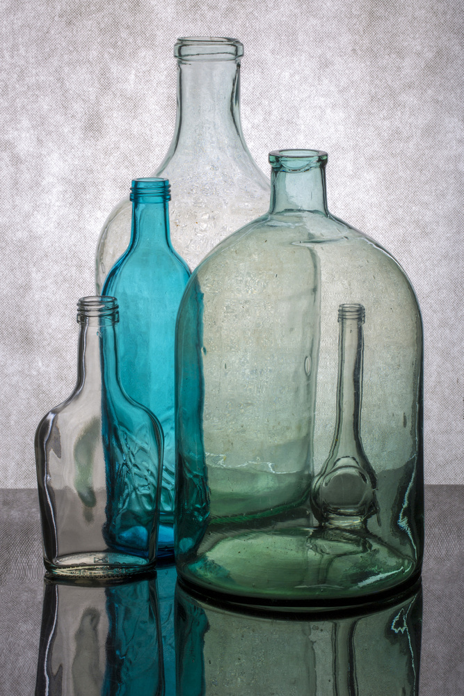 Still life with different transparent glass bottles à Brig Barkow