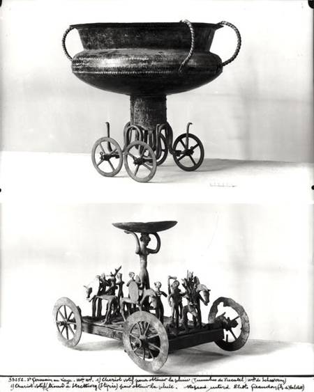 Two votive chariots for collecting rainwater: Top - cup supported on four wheels from the Peccatel t à Bronze  Age