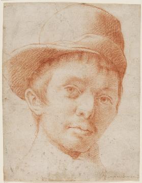 A boy wearing a workmans hat