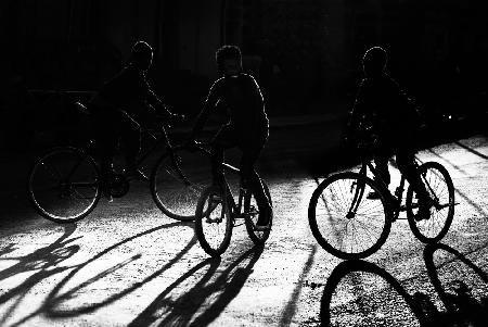 Boys, bycicles, shadow and light