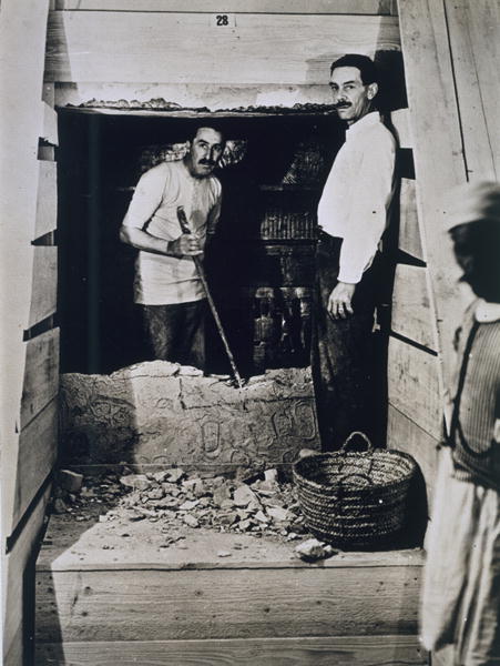 Howard Carter (1873-1939) and a colleague standing beside a partially demolished wall to one of the  à Harry Burton