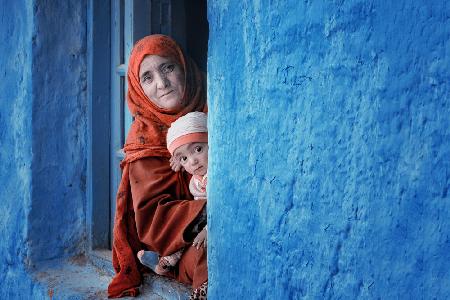 A mother and his child look out of the window