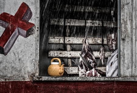 Ethiopian butcher in a rainy day.