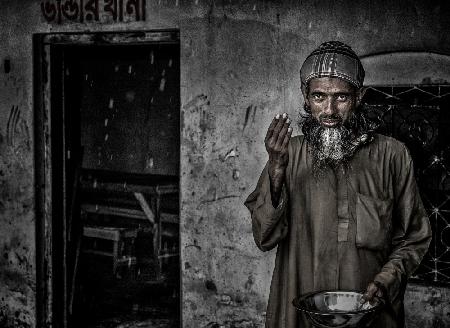 A bangladeshi man greeting in a rainy day