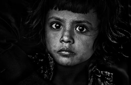 Little girl in her fathers lap - Bangladesh