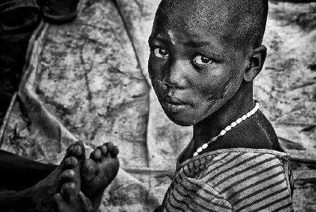 Larim tribe girl massaging feet - South Sudan