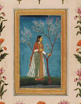 Lady standing by a tree in blossom, from the Small Clive Album