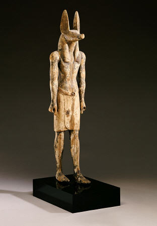 An Egyptian Wood Figure Of A Jackal-Headed Deity à 