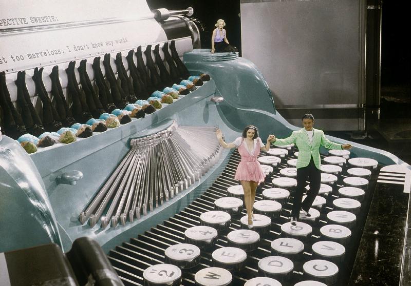 Couple dancing on the key of a giant typewriter, keys are leg of dancers, musical, 30's colourized d à 