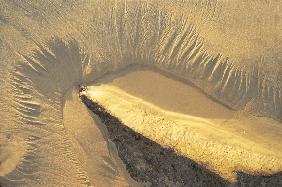 Rock and low tide marking on sand, Vishakapatnam (photo) 