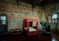 Room of the Castellana di Vergi showing the frescoed walls and frieze depicting a medieval French ro
