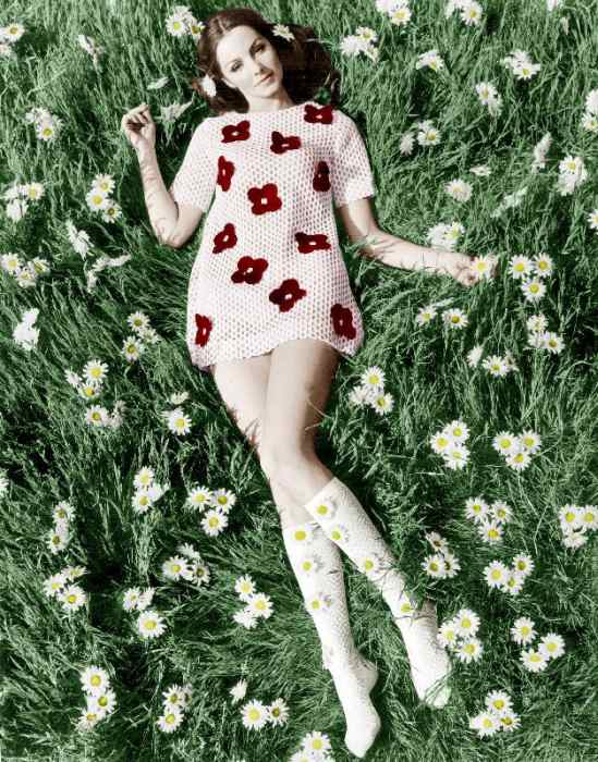 Young model Biddy Lampard in the grass wearing a short dress inspired by Courreges colourized docume à 