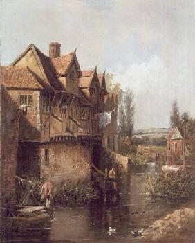 Boy fishing by a mill