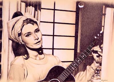 Audrey Hepburn joue de la guitare