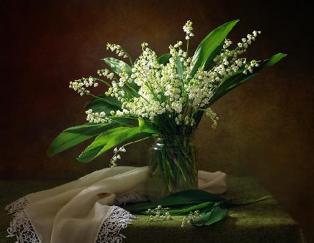With a bouquet of lilies of the valley