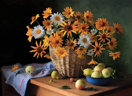Still life with a basket of summer flowers and apples