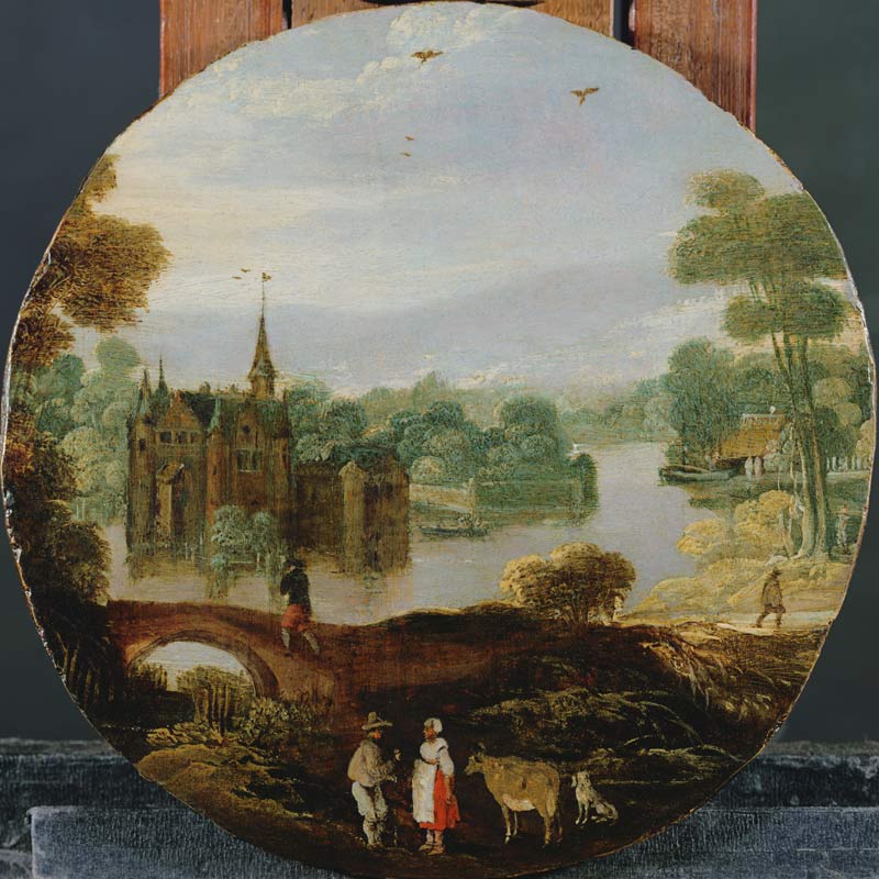 A wooded river landscape with a castle and travellers conversing à Tobias Verhaecht