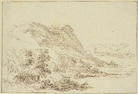 Landschaft, links ein Berg und Sträucher, rechts ein Tal im Hintergrund